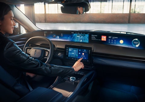 The driver of a 2024 Lincoln Nautilus® SUV interacts with the center touchscreen. | Rogers Lincoln in Midland TX