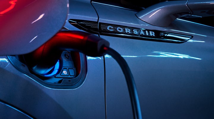 A charger plugged into the charging port of a 2024 Lincoln Corsair® Plug-in Hybrid model. | Rogers Lincoln in Midland TX